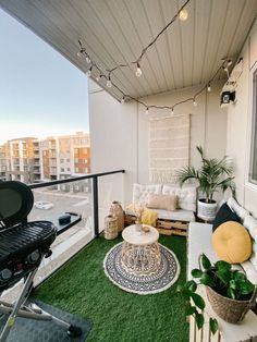 an outdoor living area with grass and plants on the balcony, potted plant next to couch