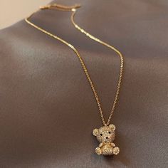 Cute Looking Teddy Bear Charm And Chain Is Well Crafted And Finished High Gloss Gold Plated. Its Embedded Crystals Looks Shiny And Real. This Will Fit Your Outfits For Everyday Or Any Occasion. Perfect Gift: This Necklace Will Be A Special Gift For Friends, Wife, Daughter, Mother, Sister, Perfect Gift For Christmas, Graduation, Birthday, Thanksgiving Day, Valentine's Dayanniversary, Graduated Day, Mother's Day. Material: Brass/Gold Plated/Rhinestone Size16.3"+2.2"Extension Chain Colorgold Teddy Bear Necklace, Teddy Bear Pendant, Pretty Jewelry Necklaces, Crystal Point Necklace, Fish Jewelry, Birthday Thanksgiving, Cute Teddy Bear, Silver Choker Necklace, Cute Teddy