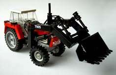 a toy tractor is shown on a white background with the front end removed from it