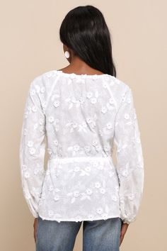 Get ready to fall in love with the charming vibes of the Lulus Wonderfully Darling White Embroidered Drawstring Tie-Front Top! Airy woven cotton, with floral embroidery and 3D floral accents throughout, shapes long raglan balloon sleeves (with elastic at the cuffs). Crew neckline features an adjustable drawstring, atop a blousy bodice with a tie detail and a matching drawstring tie at the waist. Hidden hook-and-eye closures at front. Fit: This garment fits true to size. Length: Size medium measu Lace Tops With Floral Embroidery For Brunch, Cotton Embroidered Long Sleeve Top With Lace Trim, Spring Lace Blouse With Floral Embroidery, Feminine Cotton Embroidered Top For Daywear, Spring Floral Embroidered Top For Brunch, Feminine Cotton Embroidered V-neck Top, Feminine Cotton Embroidered Top, Feminine Cotton Blouse With Floral Embroidery, Spring Lace Tops With Floral Embroidery