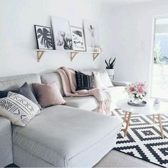 a living room filled with furniture and pictures on the wall above it's coffee table