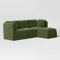 Refresh your living room decor with this 4-Piece Haven French Seam Modular Sectional from Threshold™. This upholstered modular sectional set brings a clean-lined, modern look to your interiors. It includes one armless sectional, two corner sectionals and a matching ottoman to create a cozy seating space whether you're entertaining friends, reading a book or watching TV. The dark green velvet fabric upholstery with elegant French seam detailing pairs well with any decor aesthetic, while the foam- Dark Green Cloud Couch, Olive Green Sectional Sofa, Forest Green Sectional, Dark Green Velvet Sectional, Velvet Green Couch, Big Comfy Green Couch, Friends Reading, Armless Sectional, Green Velvet Fabric