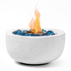 an outdoor fire pit with blue glass balls in it's center and flames coming out of the top