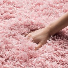 a person's foot on a pink shaggy rug