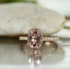 a fancy ring with an oval cut pink diamond