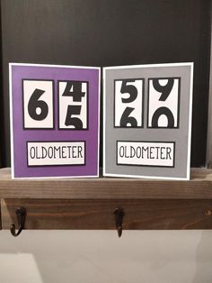 two cards with numbers on them sitting on a shelf