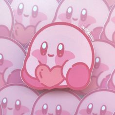 a pink sticker sitting on top of a pile of hearts