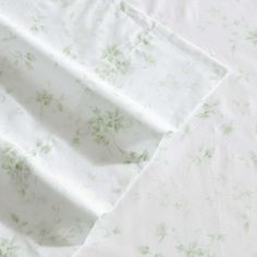 a white sheet with green flowers on it