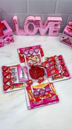 valentine's day candy and candies laid out in front of the word love