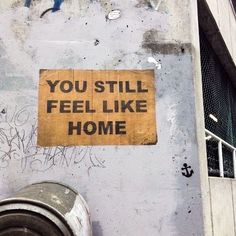 a yellow sign that says you still feel like home on the side of a building