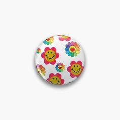 a white button with colorful flowers and smiley faces on the front, against a white background