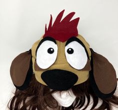 a person wearing a dog mask with long brown hair and red mohawk on it's head