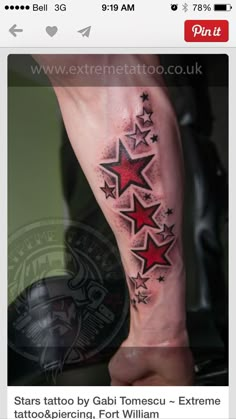 a man's arm with red stars on it and black ink in the middle