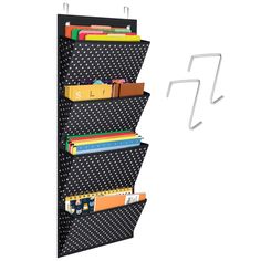 a black and white polka dot wall hanging book rack