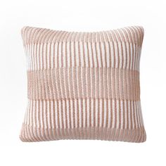 a pink and white striped pillow on a white background