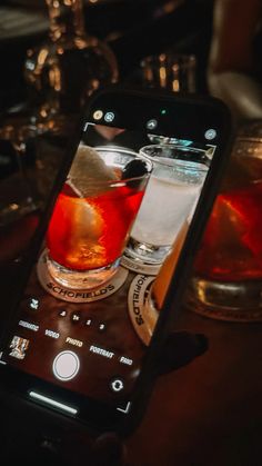 someone taking a photo of some drinks on their cell phone