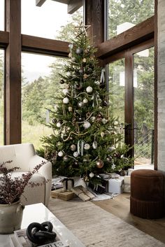 a living room with a christmas tree in the corner