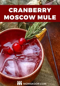 cranberry moscow mule in a bowl with ice and rosemary garnish