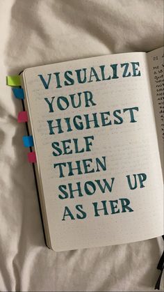 an open book with the words visualize your highest self then show up as her