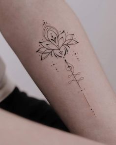 a woman's arm with a flower tattoo on the back of her left arm