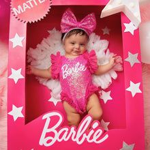 a baby doll in a pink box with white stars on it's head and name barbie