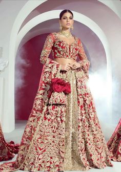 a woman in a red and gold bridal gown