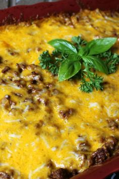 a casserole dish with meat, cheese and herbs in it on a table