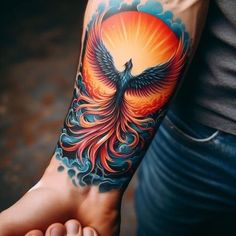 a person with a tattoo on their arm holding a bird in front of the sun