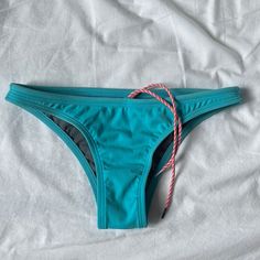 Worn Once, Selling Because Ordered A Size Too Small And Unable To Return In Time. Drawstring For Sport Wear. Slim Coverage. Some Pilling Pictured But Otherwise In Great Shape Casual Blue Brief Swimwear, Light Blue Stretchy Swimwear For Beach Party, Light Blue Brief Beach Bottoms, Turquoise Tie-side Bottom Swimwear, Light Blue Brief Swimwear For Beachwear, Eryn Krouse, Jolyn Swimwear, Cropped Rash Guard, Triangle Swim Top