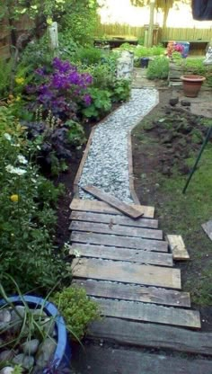 an image of a small garden with rocks and gravel on the path to the back yard