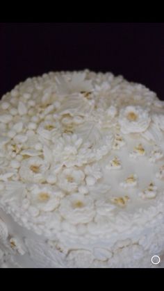 a cake with white frosting and flowers on it