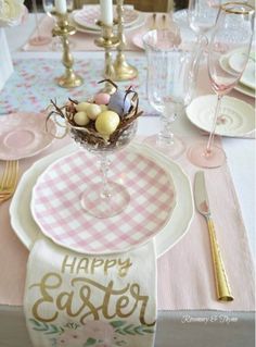 an easter table setting with pink and white napkins