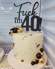 there is a white cake with black and gold decorations on the top that says truckin'm 40