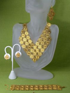 "Fabulous Etruscan Style gold plated filigree panel jewelry set/ parure: necklace, bracelet, clip on earrings and pierced earrings. The bracelet is 7 1/4\"\" long and 1 1/4\" wide and it has a flip over clasp. It has a 2\" long secure chain with the spring clasp The necklace , clip on earrings and the bracelet are marked \" D'Orlan\". The regular earrings are not marked. The inside necklace measurement is 17 inches and 5/8\" wide at the widest point.The middle ornamental piece is 6\" long and 3\ Elegant Gold-plated Filigree Jewelry Sets, Elegant Gold Plated Filigree Jewelry Sets, Handmade Gold Jewelry Sets For Party, Ornate Gold Metal Jewelry, Gold-tone Pierced Jewelry For Wedding, Formal Gold Plated Filigree Jewelry Sets, Gold Filigree Necklaces For Parties, Gold Plated Filigree Jewelry In Gold, Party Jewelry Sets With Intricate Design