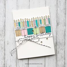 a birthday card with candles on it and some string tied around the edges, which reads happy birthday