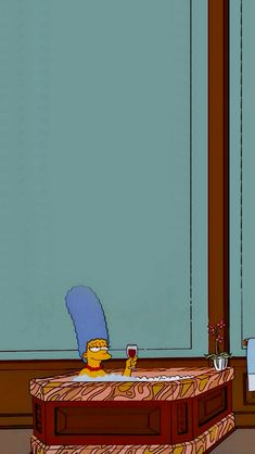 the simpsons is sitting in his living room and drinking from a wine glass while looking out the window