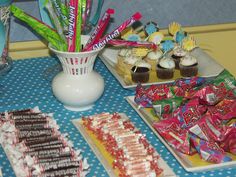 a table topped with lots of candy and cupcakes