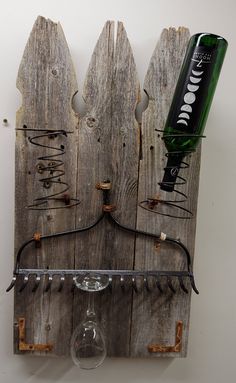 a wine glass holder made out of old pallets with metal bar handles and hooks