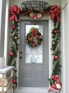 a christmas wreath is hanging on the front door