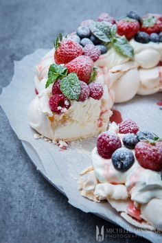 a cake with berries and whipped cream on top