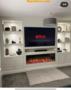 a television that is on top of a white entertainment center with the words netflix above it