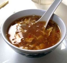 a white bowl filled with soup on top of a table