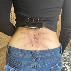 a woman has a tattoo on her stomach