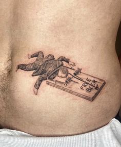 a man's stomach with a drawing of a person falling off the board on it