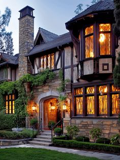 a large house with lots of windows and plants