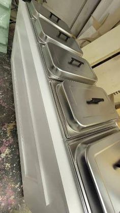 an oven is shown in the middle of a dirty kitchen floor with peeling paint on it