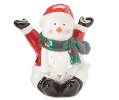 a snowman figurine sitting on the ground with his arms in the air