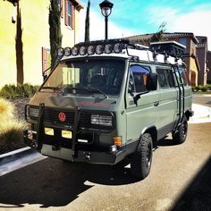 a van parked in front of a building with a light on it's roof