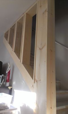 an unfinished wooden staircase in a home