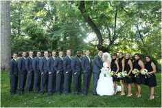 a large group of people standing in front of trees